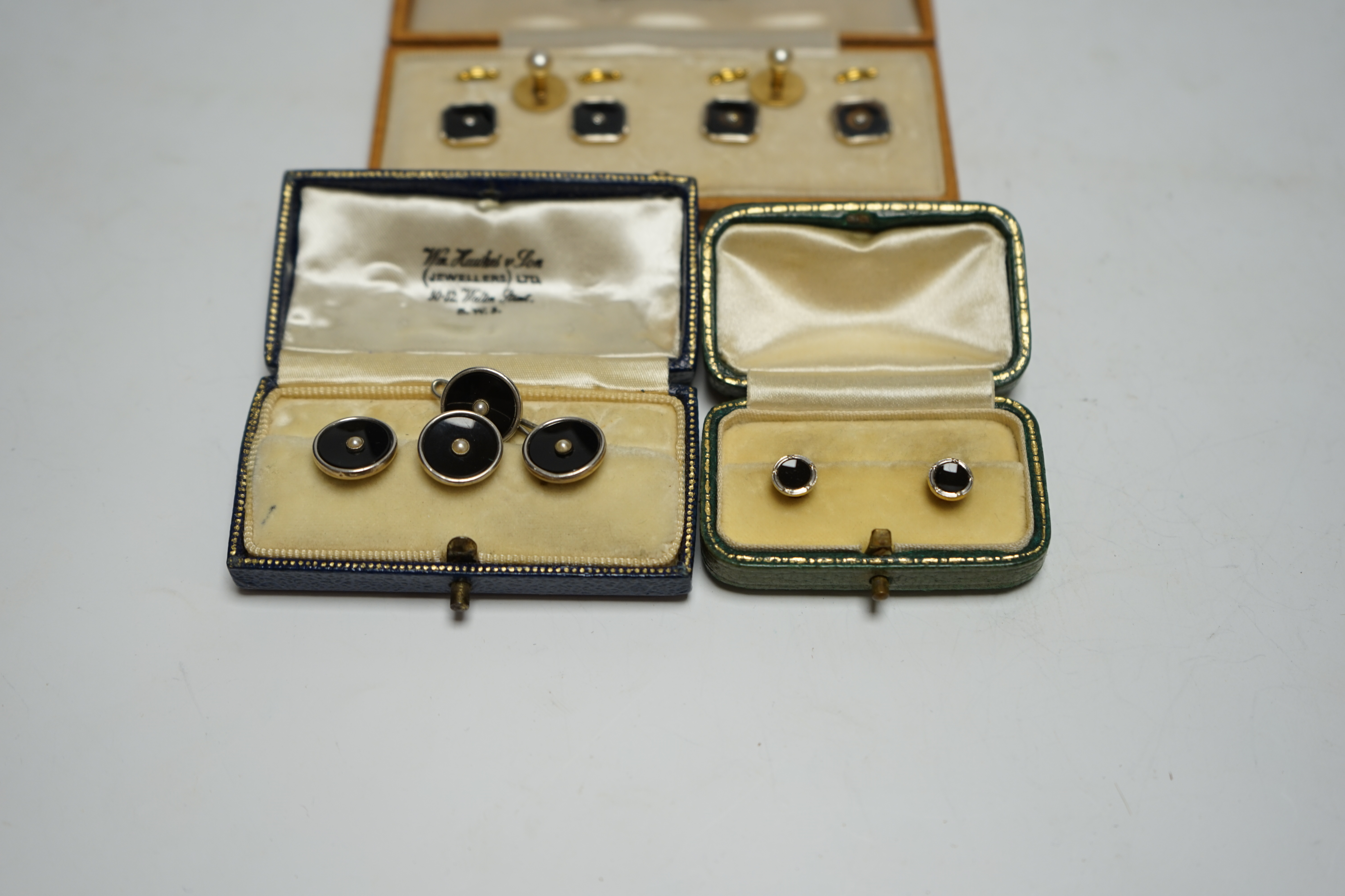 A cased set of four 18ct and plat. black onyx? and diamond set dress studs, two 18ct and cultured pearl set dress studs, four 9ct and plat. black onyx and seed pearl set dress studs and one other pair of 9ct and black on